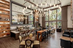 a restaurant with tables and chairs and a large chandelier at River Terrace Inn in Napa
