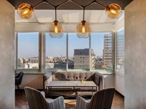 a restaurant with a table and chairs and a large window at Ibis Styles Jerusalem City Center - An AccorHotels Brand in Jerusalem