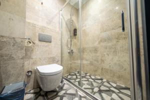 a bathroom with a toilet and a glass shower at Ornella Butik Otel in Edremit +22 photos