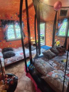 a bedroom with three beds in a room with a ceiling at Pik-Nik Sētiņa in Ventspils