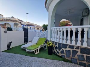 a patio with a chair on a balcony at Villa Oliver in Mazarrón
