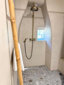 a shower with a hose in a bathroom at Sailor's apartment in Supetar +13 photos