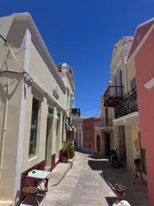 a boy walking down a street in an alley at La Maisonette de Symi in Symi