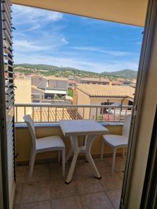 a balcony with a table and chairs and a view at Affittacamere Sofy in Villasimius