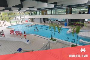 a large swimming pool in a building with people in it at " Studio Vasconia " Hyper Centre - Mezzanine -Wifi in Muret