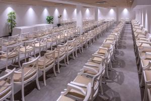 a row of white chairs in a room at Mercè in Pineda de Mar +45 photos