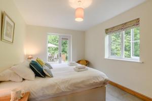 a bedroom with a large white bed with a window at 5 Bed in Hanworth Common oc-1650 in Thurgarton
