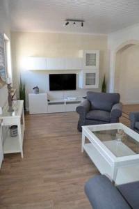 Μια τηλεόραση ή/και κέντρο ψυχαγωγίας στο Ferienhaus Am Strand