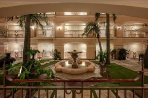 a large lobby with a fountain and palm trees at Tuli Imperial in Nagpur