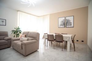 a living room with a couch and a table and chairs at A casa di Chiara in Lecce