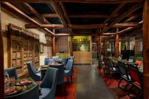 a restaurant with tables and chairs in a room at Tuli Imperial in Nagpur