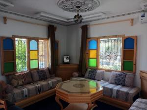 a living room with a couch and stained glass windows at Smart House in Chefchaouen