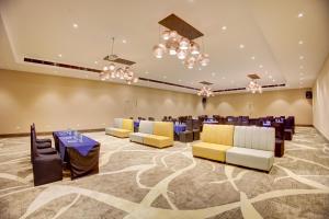 a banquet hall with tables and chairs and chandeliers at Cygnett Collection in Jim Corbett +66 photos