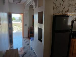 a kitchen with a refrigerator and a counter top at Smart House in Chefchaouen