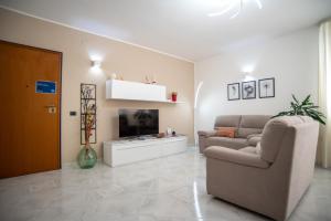 a living room with a couch and a tv at A casa di Chiara in Lecce