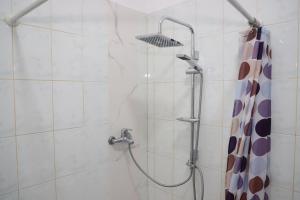 a shower with a shower head in a bathroom at A&B Berat in Berat +29 photos