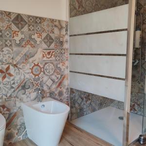 a bathroom with a sink and a toilet at New semi-detached two-room apartment in Monserrato