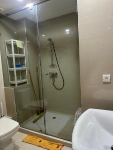 a bathroom with a shower and a toilet and a sink at Mozona beach 2 in Sidi Rahal +16 photos