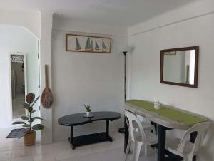 a dining room with a table and a mirror at Casa Nenen in Romblon