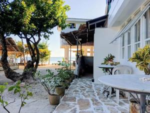 a patio with a table and a view of the ocean at Casa Nenen in Romblon