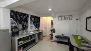 a kitchen with a counter and a table in a room at Casa Nenen in Romblon