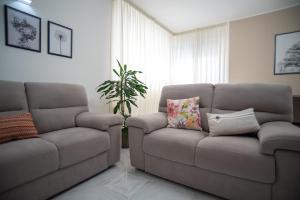a living room with a couch and a chair at A casa di Chiara in Lecce