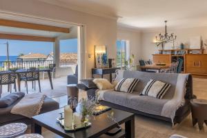a living room with a couch and a table at Villa Bollaccia - piscine privée proche de la mer in Aregno +39 photos