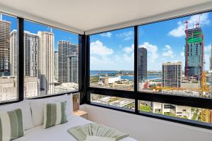 a bedroom with a view of a city skyline at District 225 Condo by Ionica in Miami