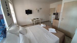 a small room with a bed and a kitchen at Budget Holiday Apartments Primorska in Pag