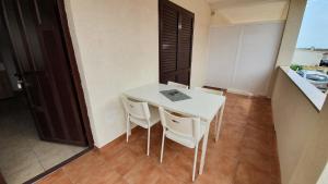 a white table and chairs in a room at Budget Holiday Apartments Primorska in Pag +46 photos