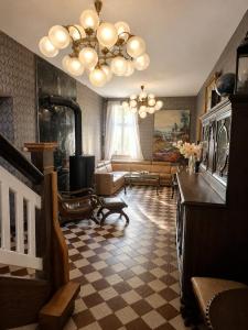 a large living room with a chandelier and a living room at Apartamenty Sunny Bear in Jelenia Góra