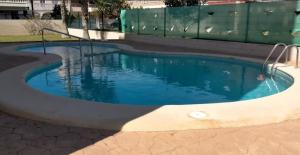 a small swimming pool with blue water at Apartamento Piles playa in Piles