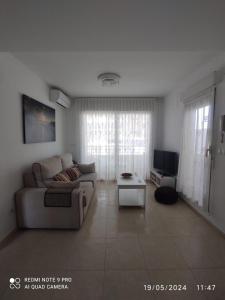 a living room with a couch and a table at Apartamento Piles playa in Piles
