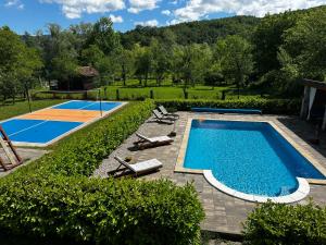 an overhead view of a swimming pool with chairs and a basketball court at Oasis of peace in Bihać