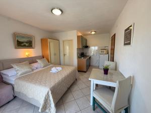 a hotel room with a bed and a table and a room at Apartments Marina in Sukošan