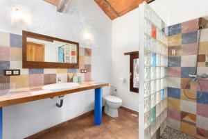 a bathroom with a sink and a toilet at Casa Miramar in Almogía +26 photos