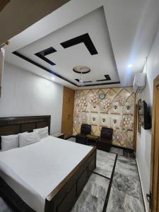 a room with a bed and a couch in it at New Palace Guest House in Islamabad