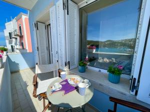 a balcony with a table with a plate of food on it at Villa Marisa - La Guarida in Ponza
