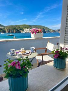 a table on a balcony with a view of the ocean at Villa Marisa - La Guarida in Ponza