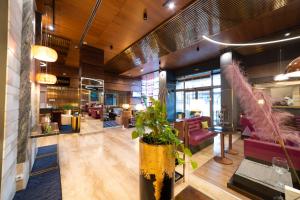 a lobby of a restaurant with a plant at Wyndham Cluj in Cluj-Napoca