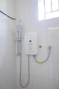 a shower in a white tiled bathroom with a shower at Volcano Visita in Cyuve +63 photos