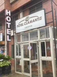 a hotel clamantins sign on the side of a building at Hotel Clamantis in Yaoundé