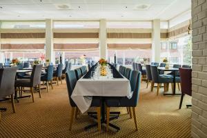 a long dining room with tables and chairs at Quality Hotel Grand Steinkjer in Steinkjer +38 photos