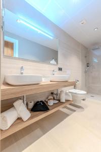 a bathroom with a sink and a toilet and a mirror at Hotel Boutique Porta Ferrisa in Alicante +43 photos