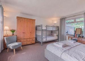 a bedroom with a bed and a desk and a chair at Big Pink House in Mealsgate