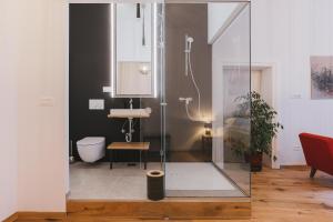 a bathroom with a shower with a sink and a toilet at Sobe Lotrist in Radovljica