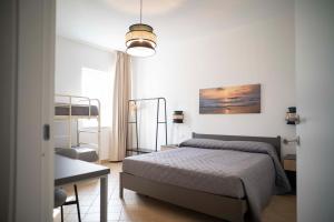 a bedroom with a bed and a table and a lamp at Relais Terramare in Cellole