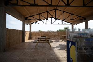 a pavilion with picnic tables and a fence at Relais Terramare in Cellole
