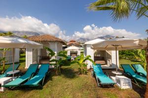 a group of chairs and umbrellas at a resort at Crystal Prestige Pearl Collection in Kemer