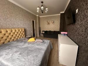 a bedroom with a bed and a couch at 1 комн.квартира in Balqash +5 photos
